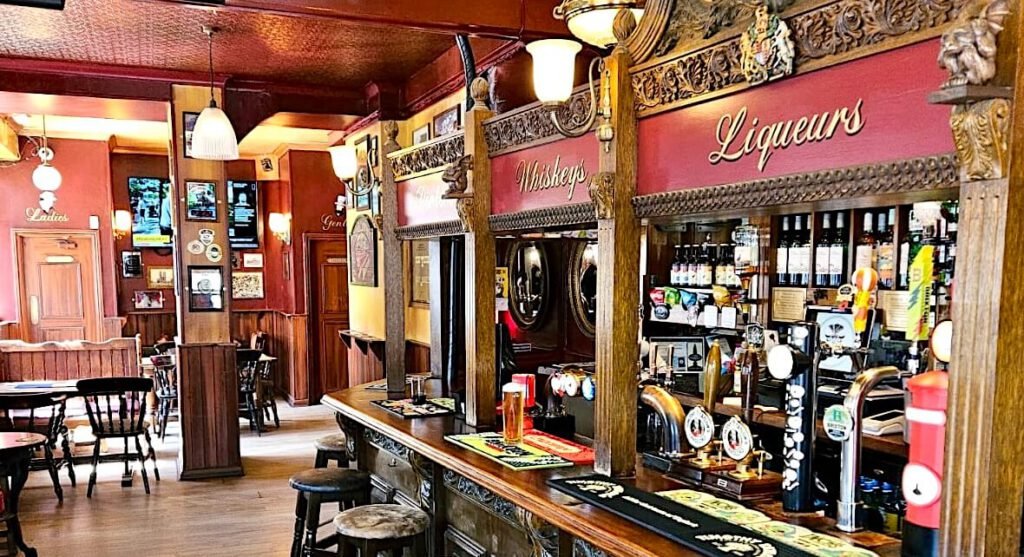 Traditional wooden bar at the Prince of Wales, Pimlico, London sw1, serving real ales and craft beer.